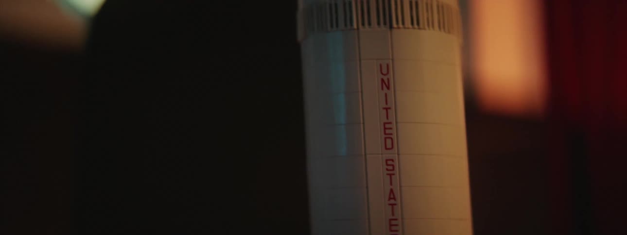 Close up of a toy model of a rocket inside a dimly lit room