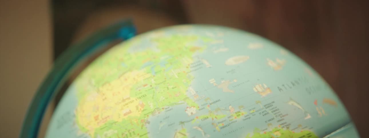 A large globe of earth sits near a window