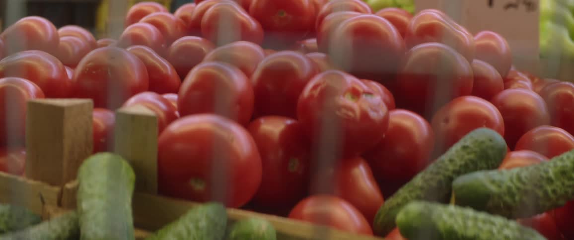 A person is shopping for produce at a market