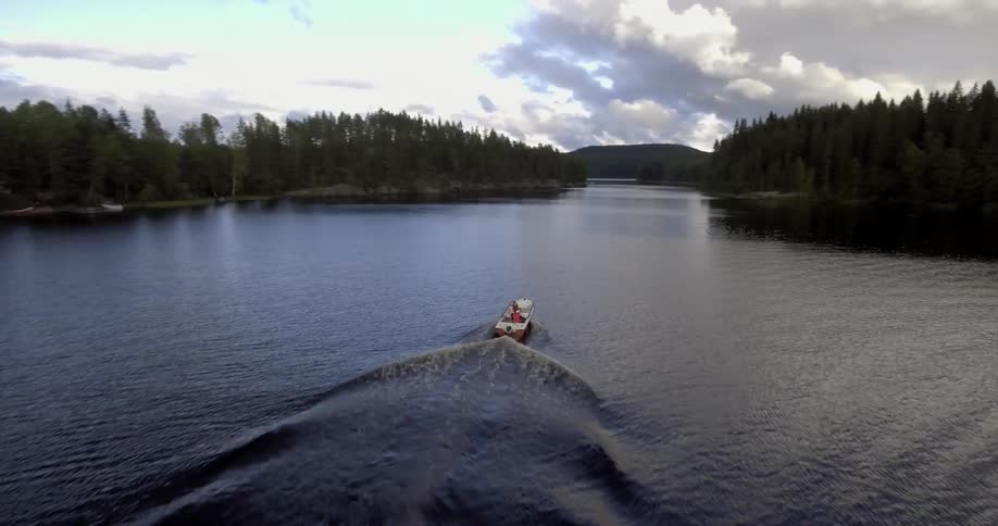 A boat sails fast in a lake