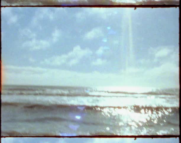 Sunlight over the ocean waves washing the wet sand on a beach