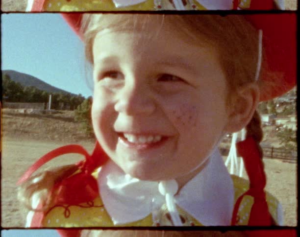A close up of a child in a costume