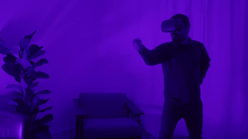A man is using a virtual reality headset indoors