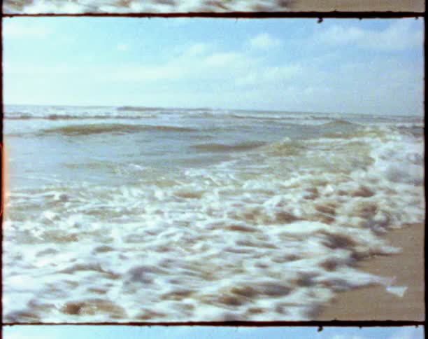 Man running over the sand on the beach next to the ocean in a clear day