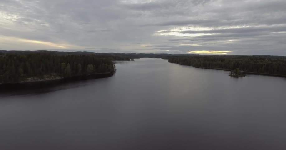 A lake sits calm at sunset
