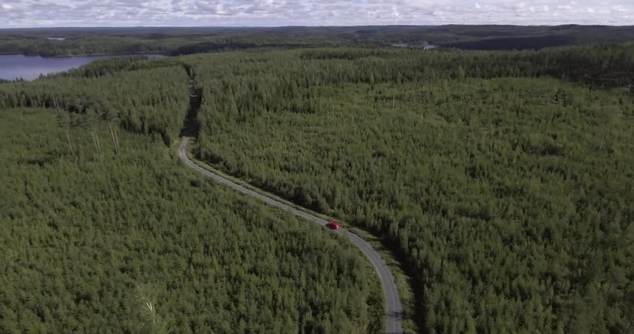 Aerial view of a winding road with one car traveling