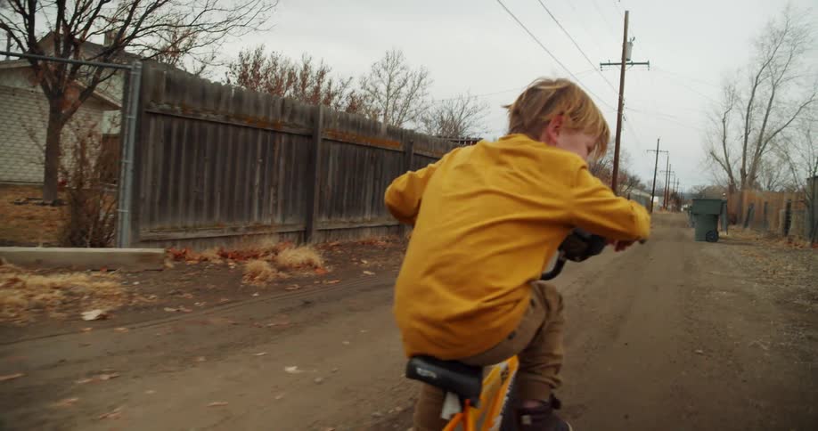 A child is riding a bike in a neighborhood