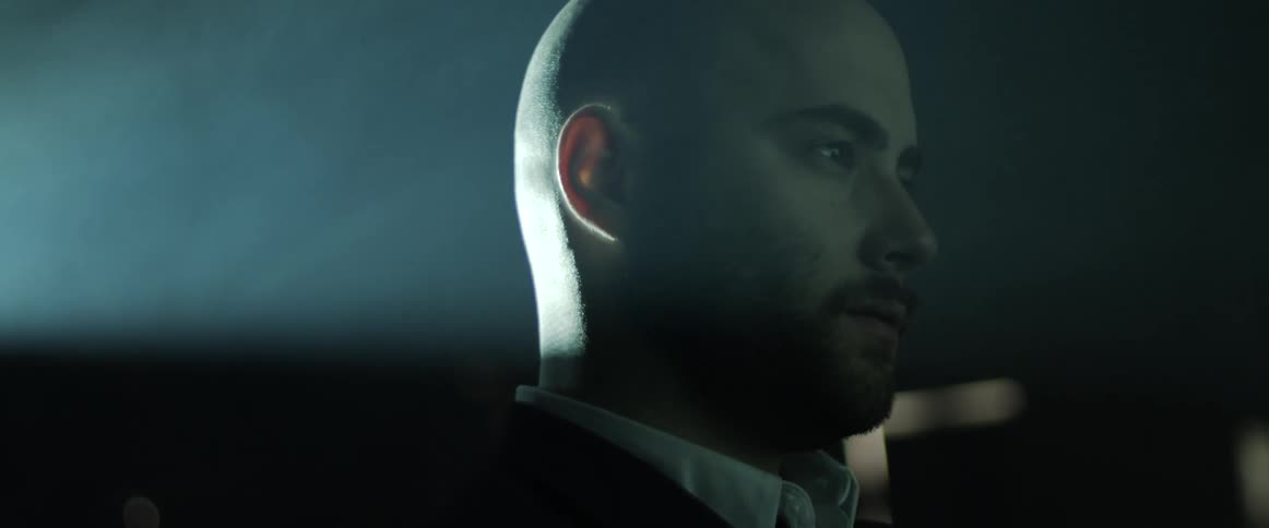 A portrait of a person with light behind him