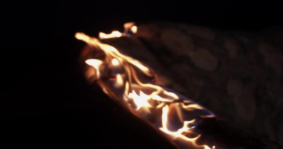 A couch on fire burning with flames and smoke