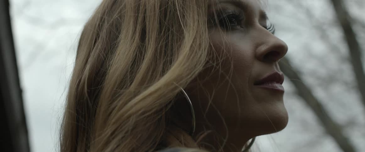 A woman looking around outdoors