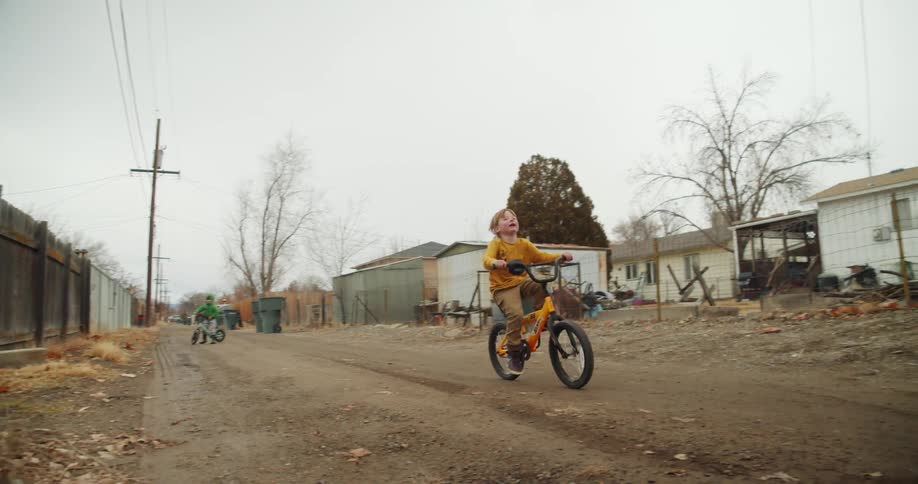 A child is riding his bike down the trail