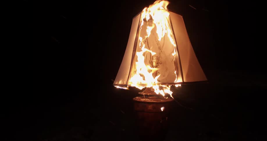 A lamp burning outdoors at night