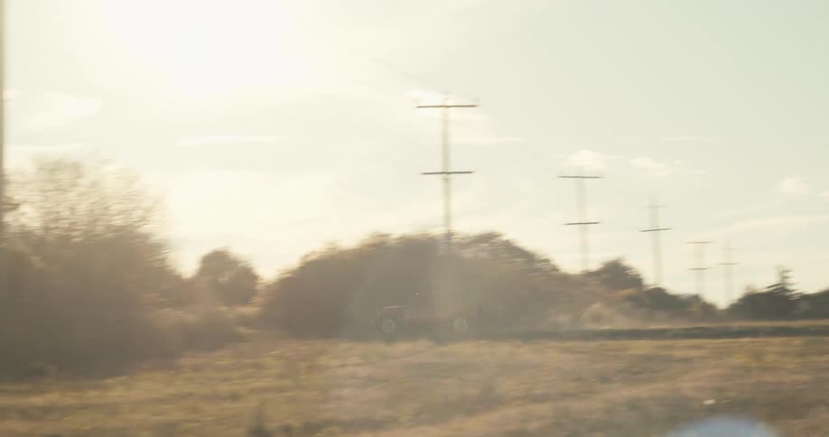 A vehicle is driving on the dirt trail