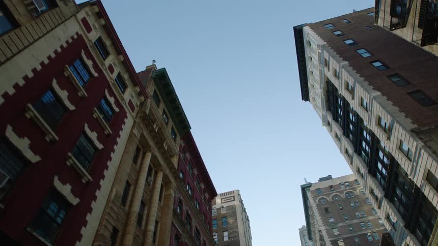 A city with buildings with windows with the sky and clouds above