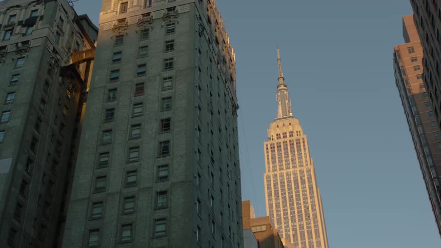 Tall skyscrapers towering over a city street in the daytime
