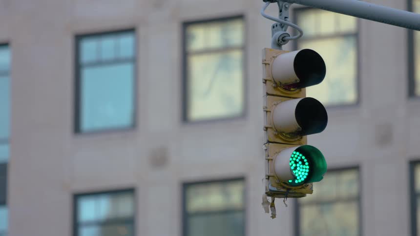 A view of a traffic light in a city