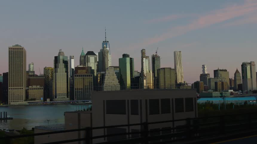 Tall skyscrapers in the distance at sunrise in a city