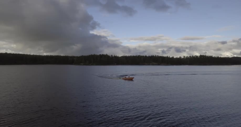 A boat is moving fast across a lake