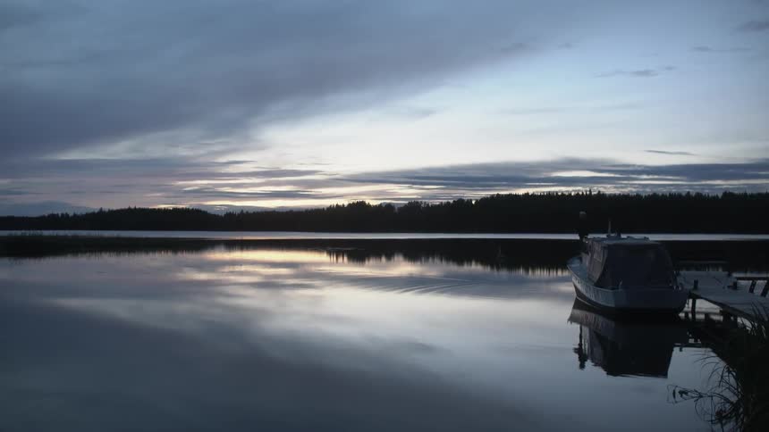 A boat is docked at sunset