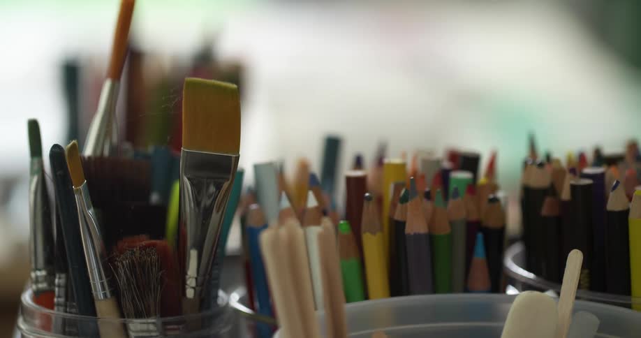 Still shot of art supplies in jars that are filmed close up