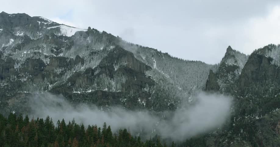 A view of mountains and fog around them