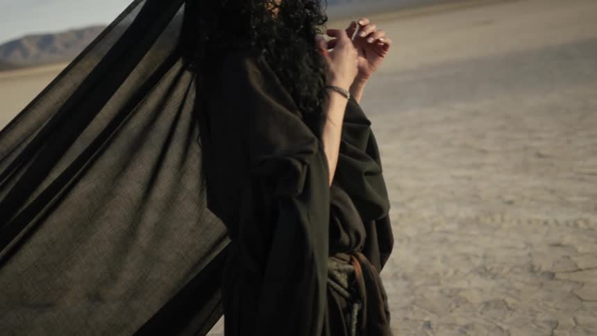 A woman walking around on a dry lake bed