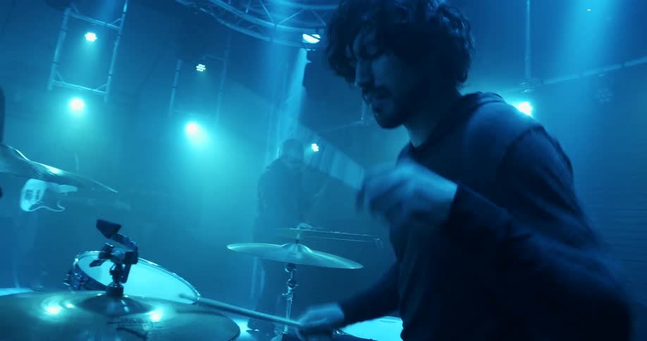 A man playing drums on a stage
