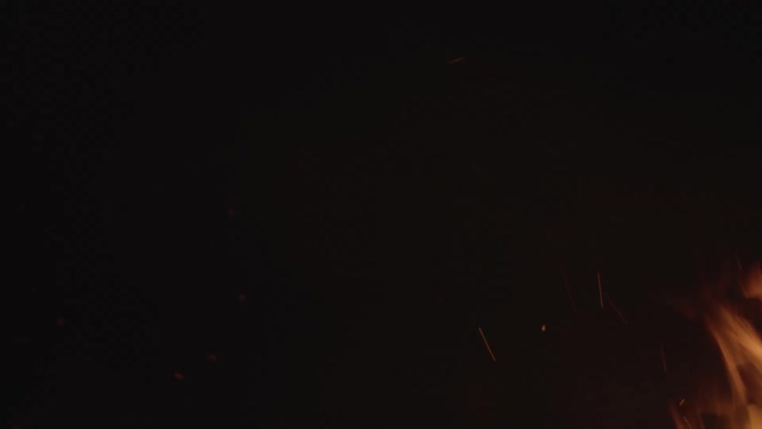 The fire rises and sparks at night