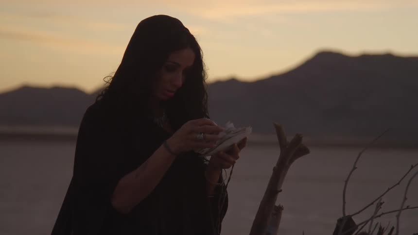 A woman putting paper onto pieces of wood