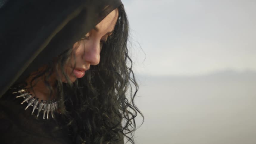 A woman is standing outdoors during the day