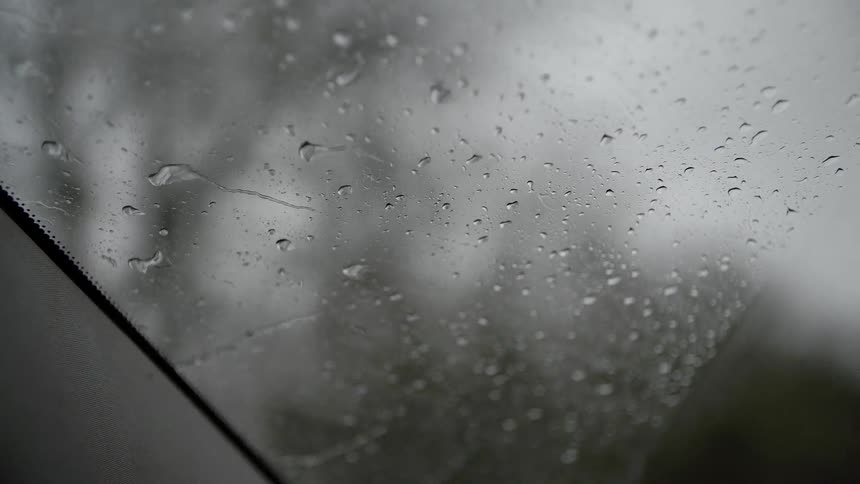 A windshield of a car on a rainy day