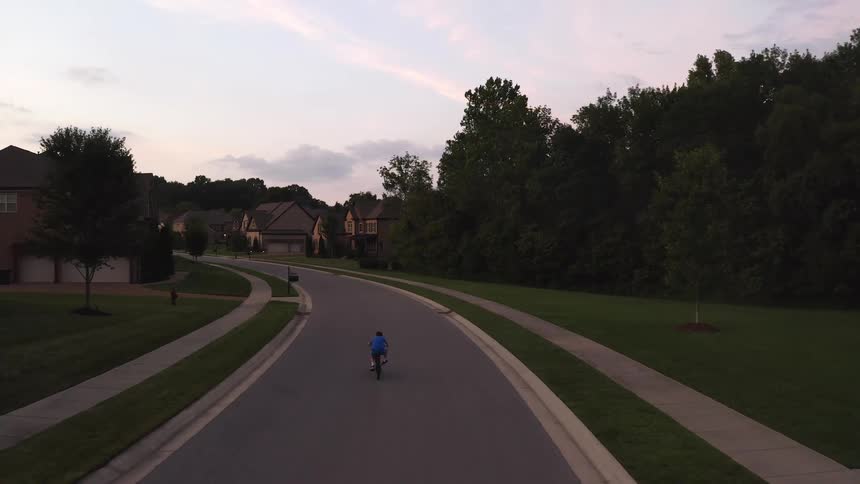 A child riding a bike down the road