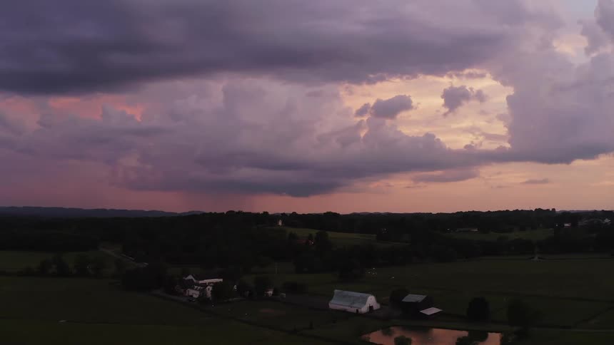 Rural countryside under a colorful cloudy sky