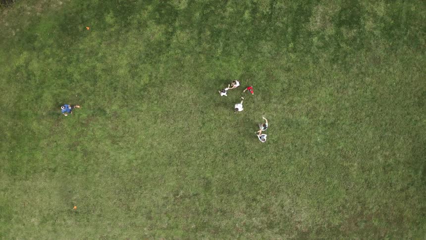 A group of people playing football in an open field