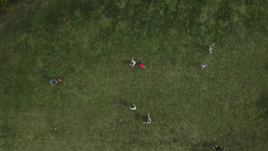 A group of people playing football in an open field