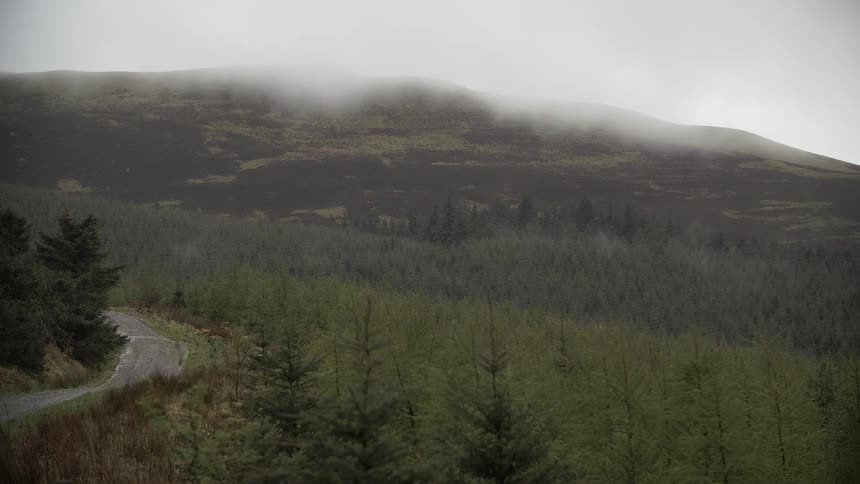 Time lapse of fog creeping down over a mountain