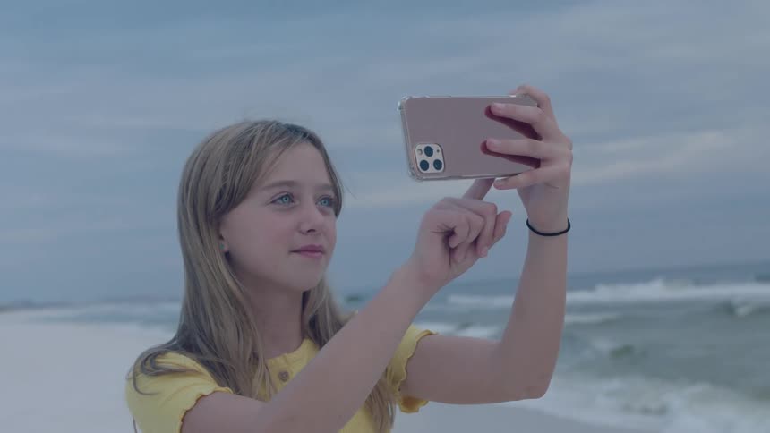 A girl taking a selfie at the beach