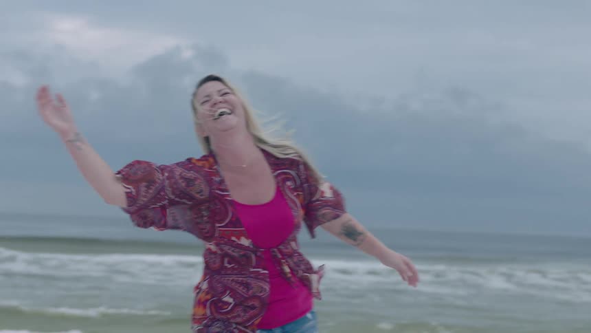 A woman playing volleyball on a beach