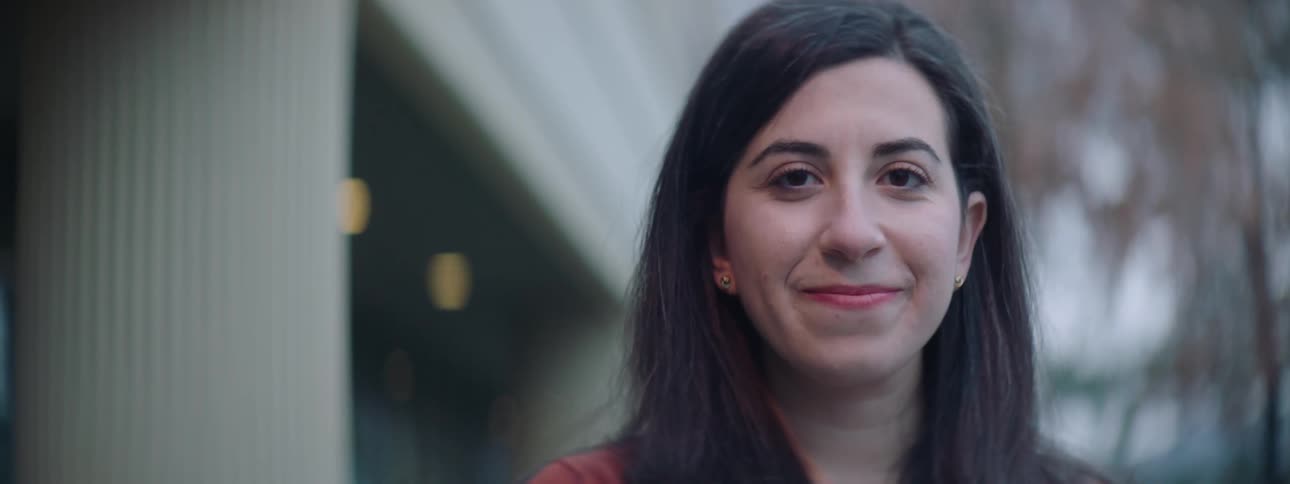 A woman turning and smiling at the camera