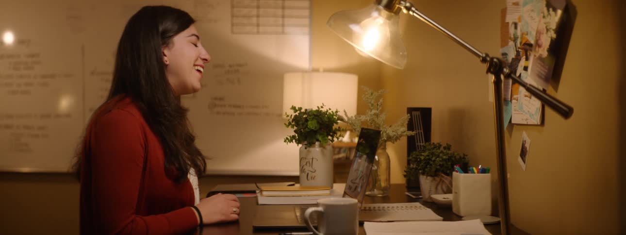 Woman having a video call on a laptop in her office