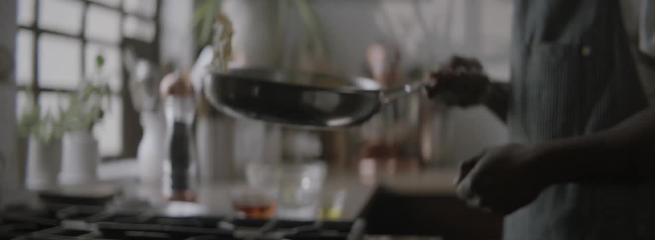 A person flips eggs in a skillet