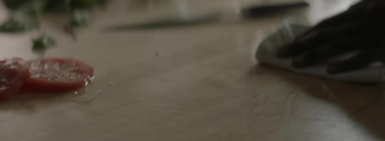 Someone cleans a knife and counter