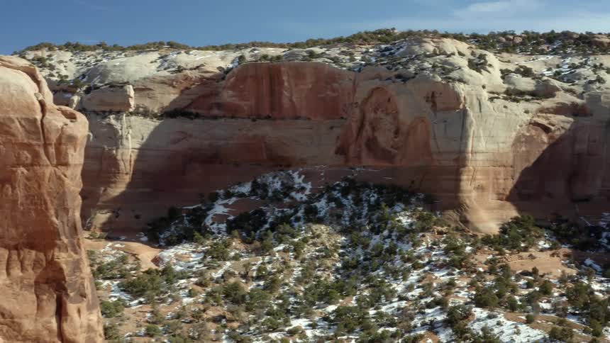 An aerial view of rocky cliffs in a canyon on a winter day