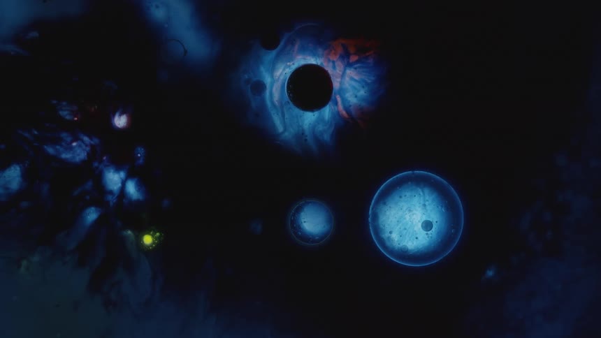 Planet like blobs and spherical orbs moving and floating on liquid simulating space