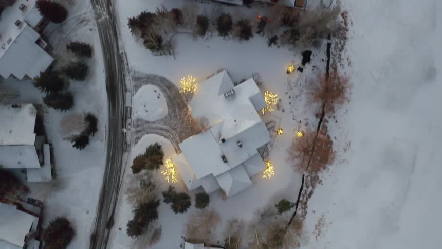 An aerial view of houses in a snow covered neighborhood