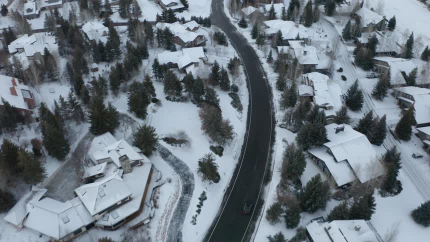 An aerial view of a car driving through a rural area
