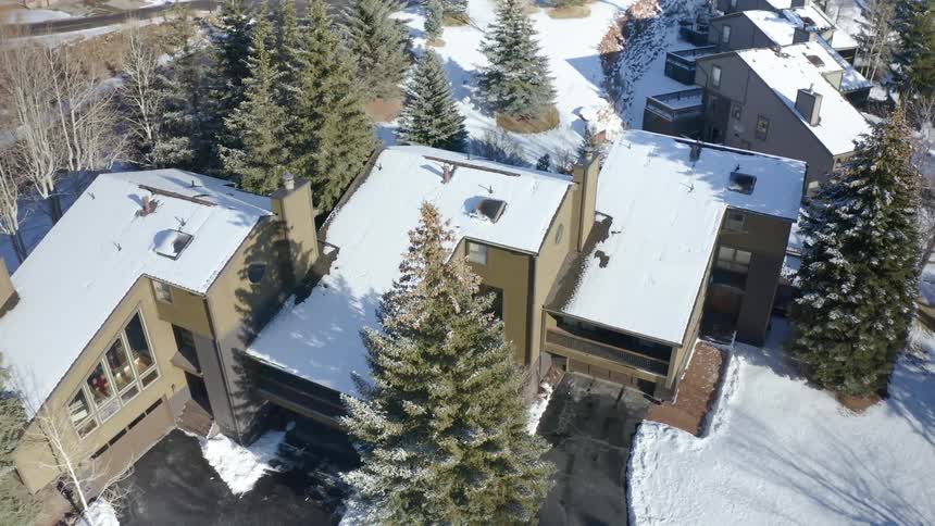 Aerial view of houses in a snow covered town in the hills