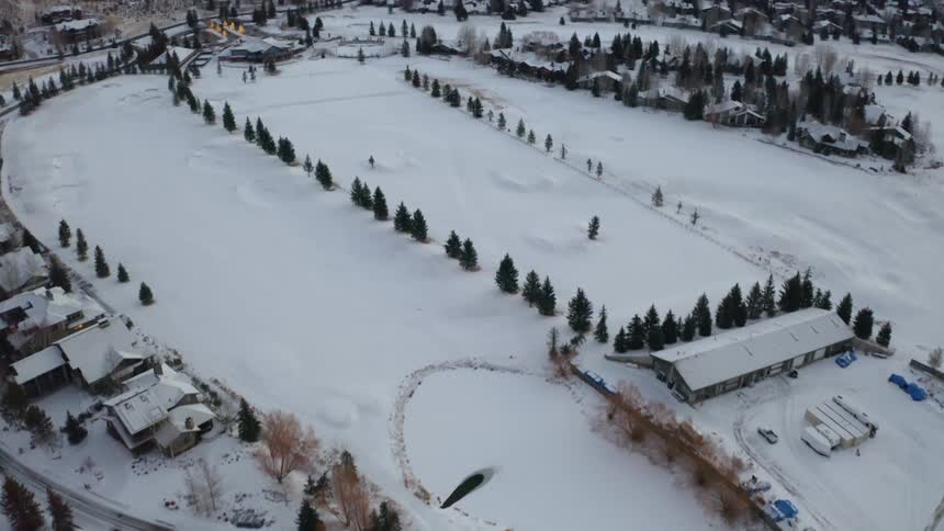 Aerial view of houses in a small town covered in white snow at winter in the mountains