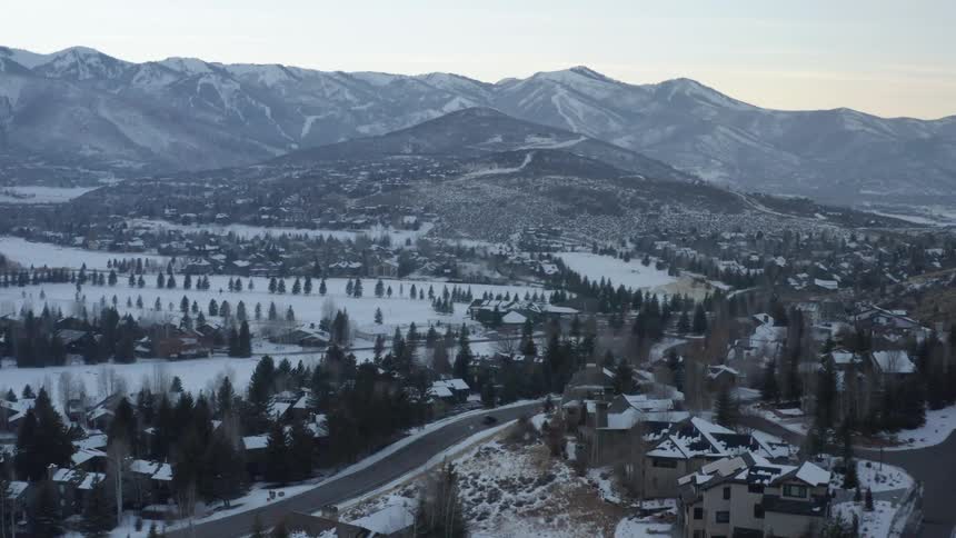 The mountains and homes are covered with snow