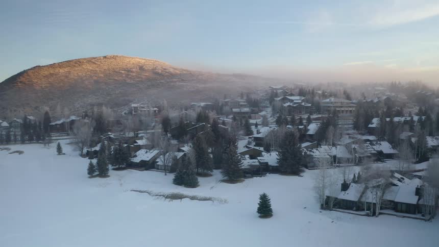 An aerial view of houses in a neighborhood on a cold winter morning